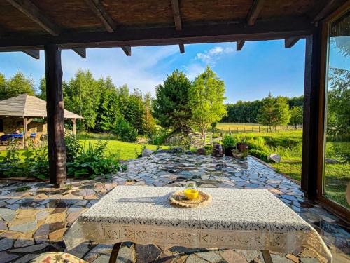 a stone patio with a table in the middle at Domek Stojkowo in Stojkowo