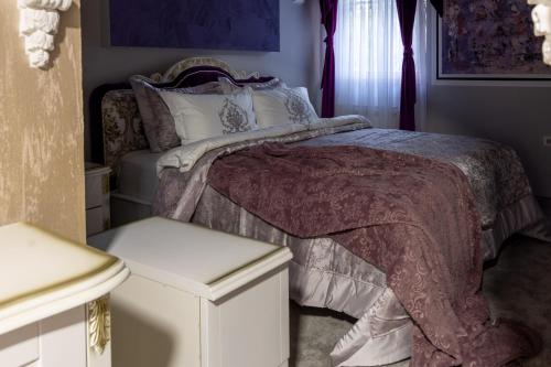 a bedroom with a bed and two white cabinets at Aparthotel AA in Sarajevo