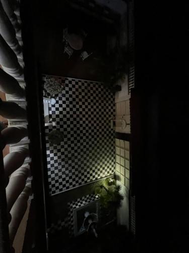 a small bathroom with a black and white tiled wall at Guest House Pulake in Berat