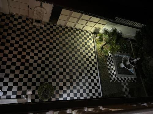 a black and white checkered tile on a wall at Guest House Pulake in Berat