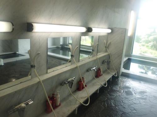 a bathroom with fire hydrants on a wall with mirrors at Hotel Bellreef Otsuki - Vacation STAY 43782v in Otsuki