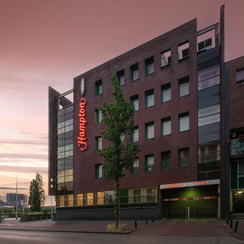 a building with a sign on the side of it at Hampton by Hilton Amsterdam Centre East in Amsterdam