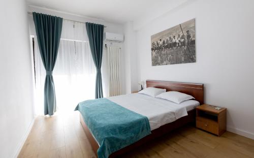 a bedroom with a bed and a large window at Obor Central Oasis --Self Check-in- Private Parking - 1min Metro Station in Bucharest