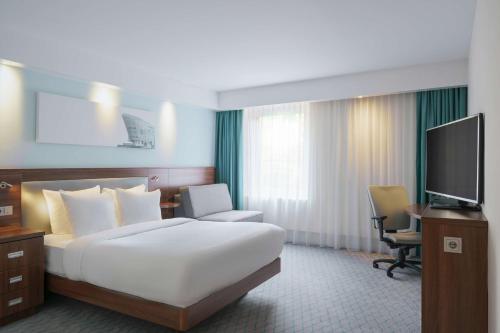 a hotel room with a bed and a television at Hampton by Hilton Amsterdam Centre East in Amsterdam