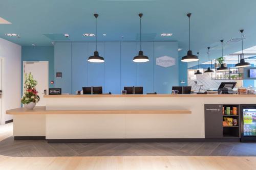 an empty lobby with blue walls and a reception desk at Hampton By Hilton Utrecht Centraal Station in Utrecht