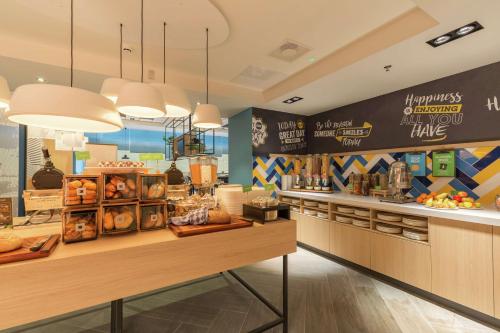a bakery with a counter with bread and pastries at Hampton By Hilton Utrecht Centraal Station in Utrecht