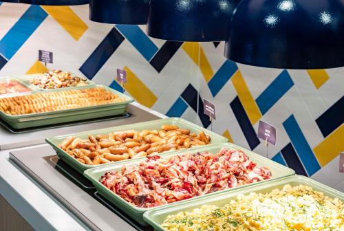 a buffet of different types of food on a table at Hampton By Hilton Amsterdam Arena Boulevard in Amsterdam