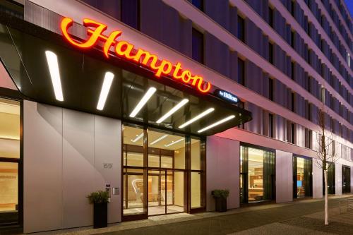 a neon sign on the front of a building at Hampton by Hilton Berlin City Centre Alexanderplatz in Berlin