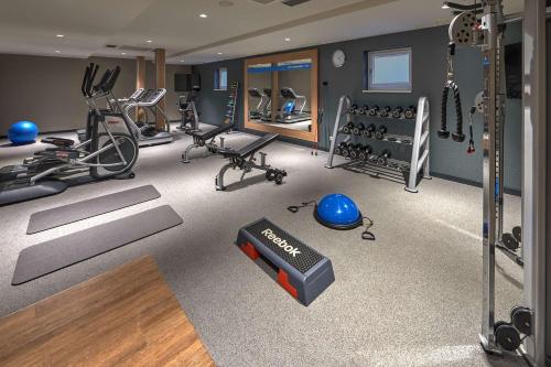 a gym with several treadmills and exercise equipment at Hampton by Hilton Berlin City Centre Alexanderplatz in Berlin