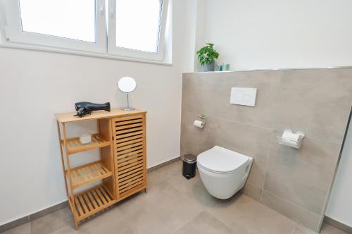 a bathroom with a toilet and a sink at Großzügig & individuell - Balkon - WiFi - TV in Bielefeld