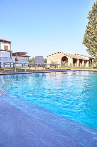 a large pool of blue water in front of a building at Agriturismo La Foscarina in Vescovana