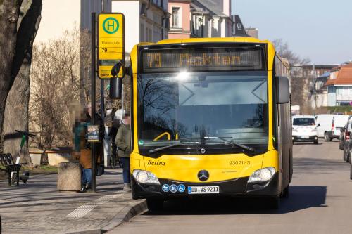 a yellow bus is driving down a city street at Studioatelier in Übigau in Dresden