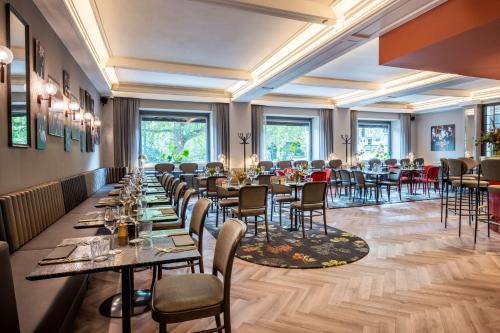 a long dining room with tables and chairs at DoubleTree By Hilton Brussels City in Brussels