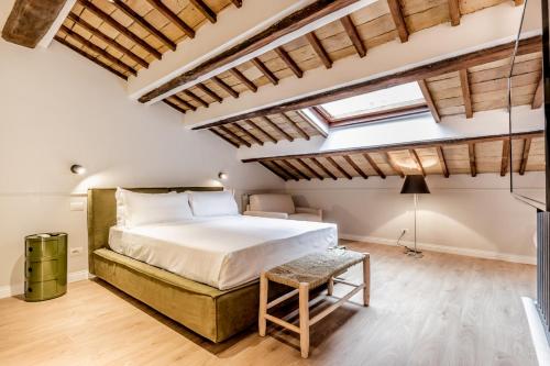 a bedroom with a large bed and skylights at APT ROME - Vittoria Palace in Rome
