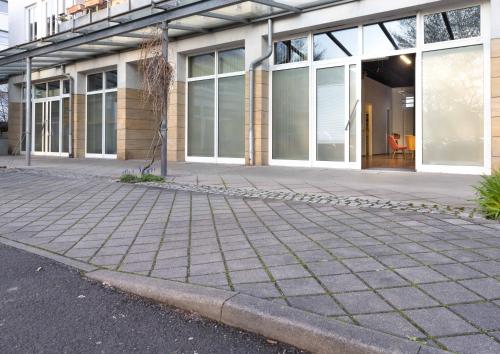 a building with a sidewalk in front of it at Studioatelier in Übigau in Dresden