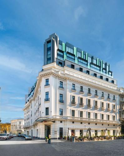a large white building sitting on top of a street at Hilton Garden Inn Bucharest Old Town in Bucharest