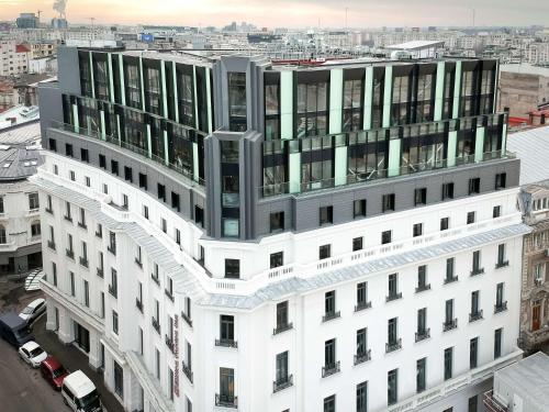 an aerial view of a white building with windows at Hilton Garden Inn Bucharest Old Town in Bucharest