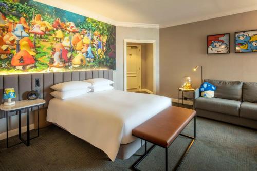 a bedroom with a large bed and a couch at Hilton Brussels Grand Place in Brussels