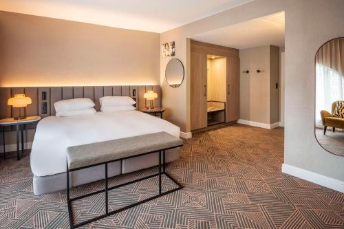 a hotel room with a bed and a bathroom at Hilton Brussels Grand Place in Brussels