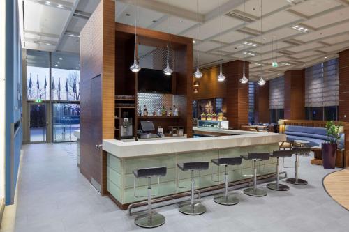 a restaurant with a bar with stools at Hampton By Hilton Bursa in Bursa