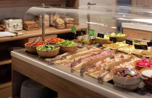 a buffet line with many different types of food at Hilton Garden Inn Bucharest Old Town in Bucharest