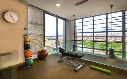 a gym with a large window and a clock at DoubleTree by Hilton Yerevan City Centre in Yerevan