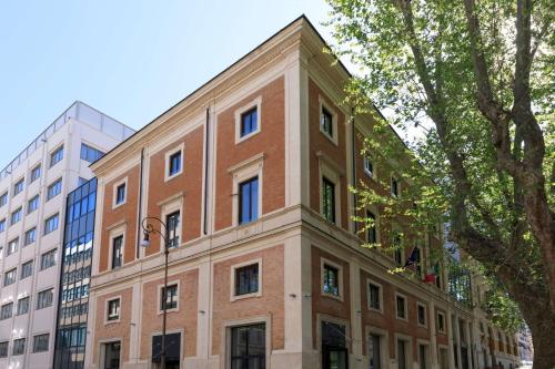 a large brick building in front of some buildings at DoubleTree By Hilton Rome Monti in Rome