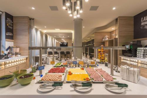 a buffet line with many different types of food at Hampton By Hilton Frankfurt Airport in Frankfurt/Main