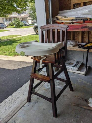 a wooden chair with a surfboard on top of it at Adorable 4 bed,3 bath house in Kingston