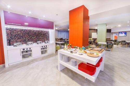 a kitchen with a counter with food on it at Hampton By Hilton Iasi in Iaşi