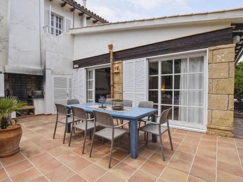 a blue table and chairs on a patio at Belvilla by OYO Blu Marine in Font de Sa Cala