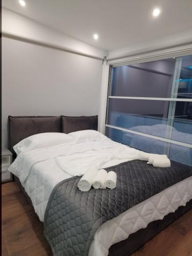 a bedroom with a bed with two towels on it at Villa Pearl Adriatic Coast 4 in Golem