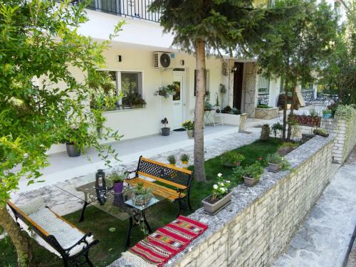 a garden with a bench and a table at Garden appartment in Ioannina