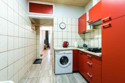 a small kitchen with a washing machine in it at Juozapaviciaus apartment in Kaunas