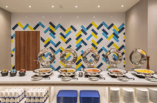 a buffet with bowls of food on a table at Hampton By Hilton Munich City West in Munich
