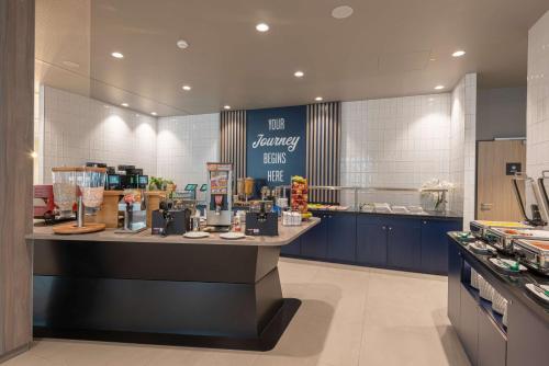 a kitchen with a counter in a restaurant at Hampton By Hilton Munich City North in Munich