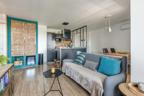 a living room with a couch and a kitchen at Beautiful 2-room apartment with a view in Lyon - Welkeys in Lyon
