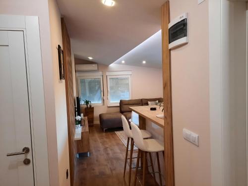 a kitchen and living room with a table and chairs at Dream Home, FREE GARAGE in Niš