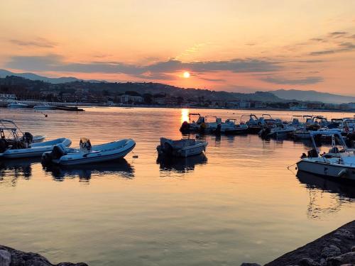 a group of boats in the water at sunset at Casa Annalisa in Scauri