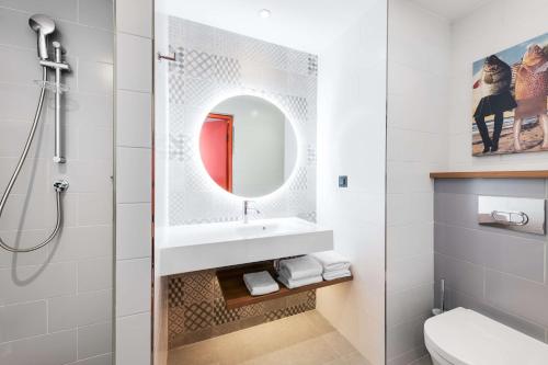 a bathroom with a sink and a mirror at Hampton By Hilton Moscow Rogozhsky Val in Moscow