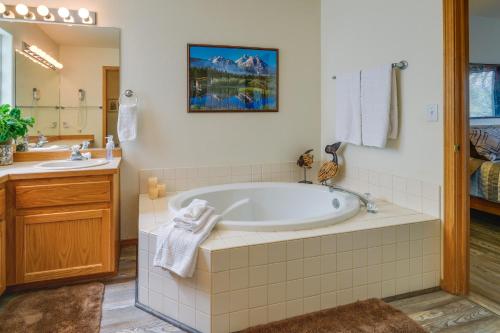 a bathroom with a tub and a sink at Resort-Style Klamath Falls Home, Golf Course View! in Klamath Falls
