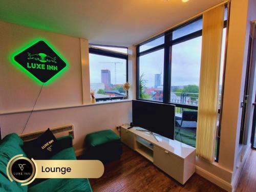 a living room with a tv and a large window at Bull's Ring 3Bed Penthouse City Centre in Birmingham