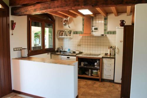 a kitchen with a counter and a white refrigerator at Casa AsCampinas in Ourense