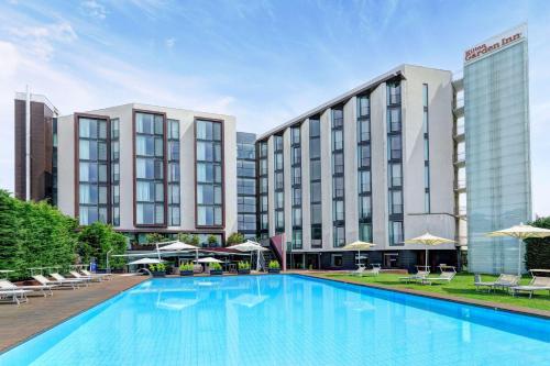a large pool in front of a hotel at Hilton Garden Inn Venice Mestre in Mestre