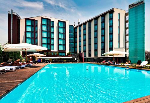 a large swimming pool in front of a hotel at Hilton Garden Inn Venice Mestre in Mestre