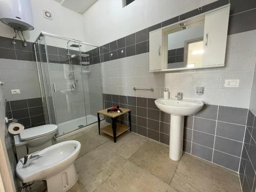 a bathroom with a sink and a toilet and a mirror at Case Perrone in Grisolia