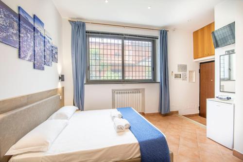 a small bedroom with a bed and a window at Anagnina Apartment in La Romanina