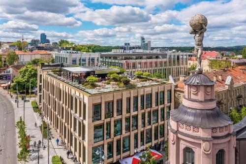 a city with a statue on top of a building at Hilton Garden Inn Vilnius City Centre in Vilnius