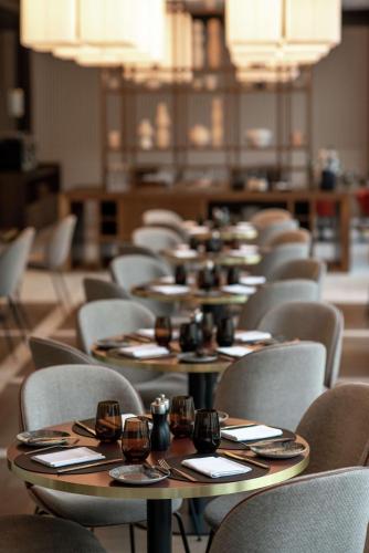 a row of tables and chairs in a room at Hilton Garden Inn Vilnius City Centre in Vilnius