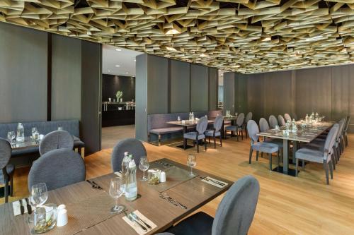 a dining room with long tables and chairs at Doubletree by Hilton Vienna Schonbrunn in Vienna